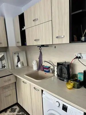 a kitchen with a sink and a washing machine at Апартаменти Уют in Plovdiv