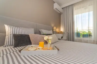 a bedroom with a bed with a tray on it at Plovdiv City Center Kapana with garage in Plovdiv