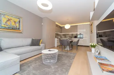a living room with a couch and a table at Plovdiv City Center Kapana with garage in Plovdiv
