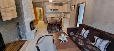 a living room with a couch and a table at Snow magic Grand Monastery in Pamporovo