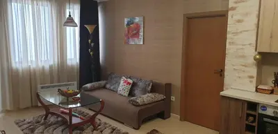 a living room with a couch and a glass table at Snow magic Grand Monastery in Pamporovo