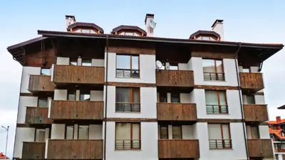 a building with wooden balconies on top of it at Luxury Green Apartment - up to 4 people in Bansko