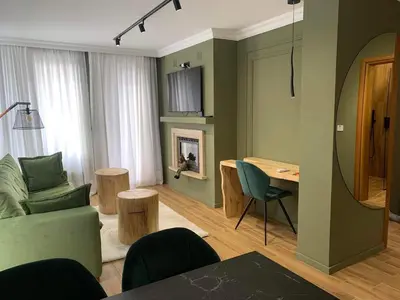 a living room with a couch and a table at Luxury Green Apartment - up to 4 people in Bansko