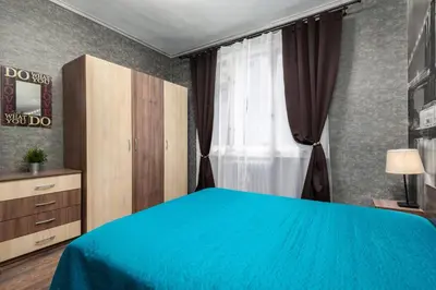 a bedroom with a blue bed and a window at VITOSHKA Pleasure place in Sofia