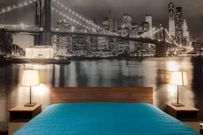 a bedroom with a blue bed with a view of a bridge at VITOSHKA Pleasure place in Sofia