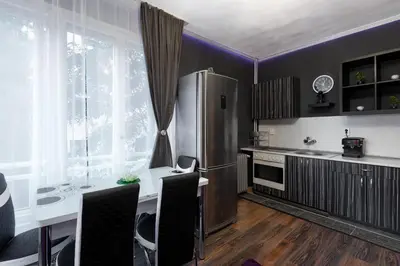 a kitchen with a table and a refrigerator at VITOSHKA Pleasure place in Sofia