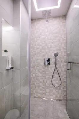 a bathroom with a shower with a glass door at South Place Apartments in Sandanski