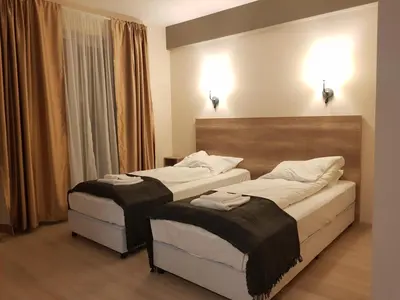 a hotel room with two beds in a room at Апартаментен туристически комплекс Аква Терми in Krasnovo