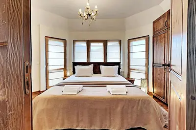 a bedroom with a large bed with two towels on it at Charming apartment in the heart of Bansko in Bansko