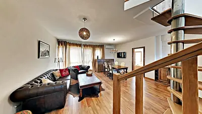 a living room with a couch and a table at Charming apartment in the heart of Bansko in Bansko