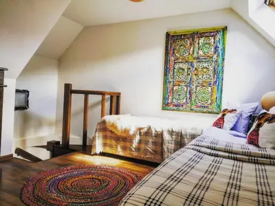 a bedroom with two beds and a window on the wall at Charming apartment in the heart of Bansko in Bansko