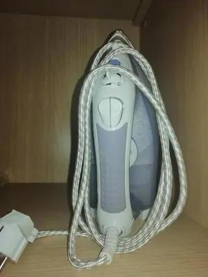 a hair dryer wrapped in a hanger on a table at Apartments in Borovets Gardens in Borovets