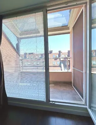 a room with a large window with blinds at Unique Luxurious Jacuzzi PENTHOUSE DUPLEX in City Center! 2 BATHS! FREE PARKING! in Sofia