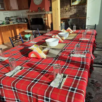 a table with a red and white plaid table cloth at Айрови in Sarnitsa
