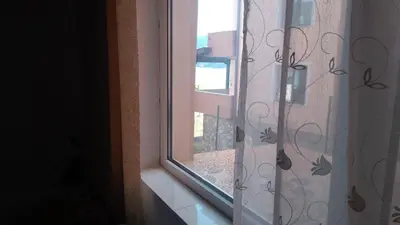 an open window with a view of a balcony at Айрови in Sarnitsa