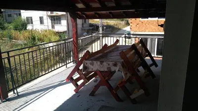 a table and two chairs sitting on a balcony at Айрови in Sarnitsa