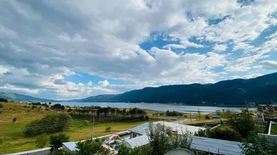a view of a body of water and mountains at Айрови in Sarnitsa