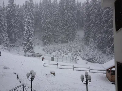 a snow covered park with a crowd of people at Ski Apartment in Castle Complex in Pamporovo