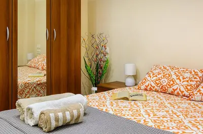 a bedroom with a bed with a book and a mirror at Luxury 2 bedroom,2 bathroom apart ,free parking in Plovdiv