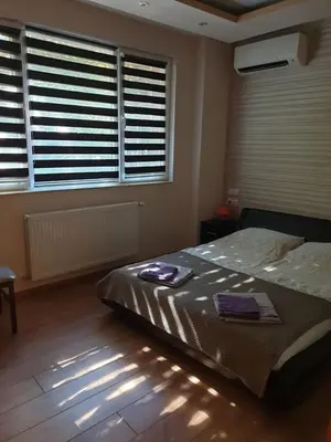 a bedroom with a bed and a window with blinds at Luxury 2 bedroom,2 bathroom apart ,free parking in Plovdiv
