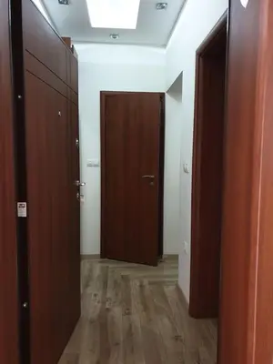a hallway with two wooden doors in a room at Luxury 2 bedroom,2 bathroom apart ,free parking in Plovdiv