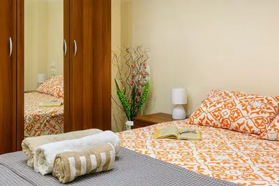 a bedroom with a bed with a book and a mirror at Luxury 2 bedroom,2 bathroom apart ,free parking in Plovdiv