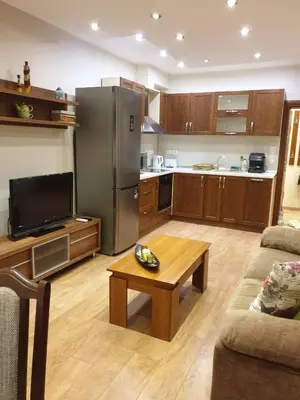 a kitchen with a refrigerator and a table in a living room at Luxury 2 bedroom,2 bathroom apart ,free parking in Plovdiv