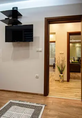 a living room with a flat screen tv on a wall at Luxury 2 bedroom,2 bathroom apart ,free parking in Plovdiv