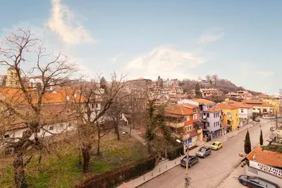 a city street with buildings and cars on the road at Stunning location and views!Foothills of Old town! in Plovdiv
