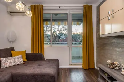 a living room with a couch and a large window at Stunning location and views!Foothills of Old town! in Plovdiv