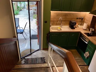 a small kitchen with green cabinets and a sink at Art Apartment 36 in Plovdiv