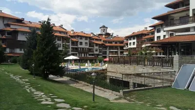 a group of apartment buildings with a swimming pool at Apartman u kompleksu Royal Towers in Bansko