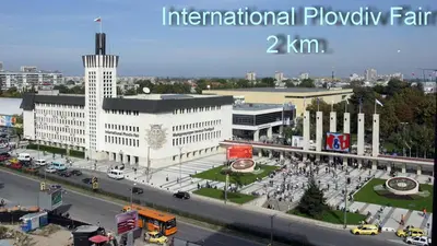 a large white building with a street in front of it at Central Square Apartment in Plovdiv