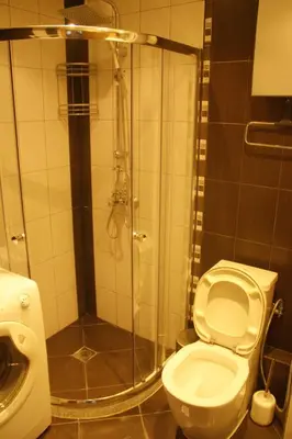 a bathroom with a shower with a toilet and a sink at Central Square Apartment in Plovdiv