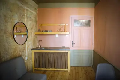 a bathroom with a sink and a mirror and a door at Beautiful best location apartment Red Mouse in Plovdiv