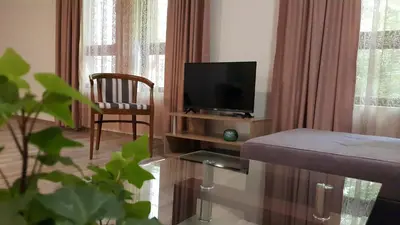 a living room with a television and a chair at Art House Plovdiv in Plovdiv