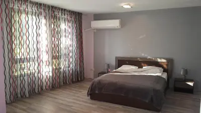 a bedroom with a bed and a large window at Art House Plovdiv in Plovdiv