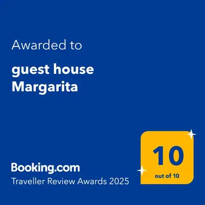 a yellow sign with the text awarded to guest house margarita at guest house Margarita in Bryagovo