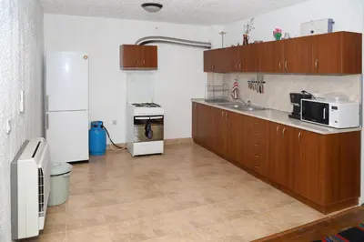 a kitchen with a sink and a refrigerator at guest house Margarita in Bryagovo