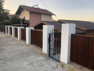 a fence with a gate in front of a house at Vila Rila in Sapareva Banya