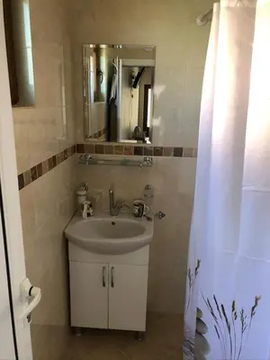 a bathroom with a sink and a mirror at Vila Rila in Sapareva Banya