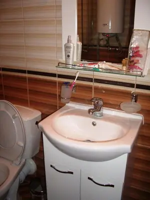a bathroom with a sink and a toilet at Cozy Studio in Mountain Lake Complex Smolyan Pamporovo in Smolyan