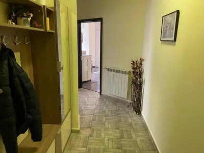 a hallway with a door leading into a room with a floor at Апартамент Мия Deluxe in Velingrad