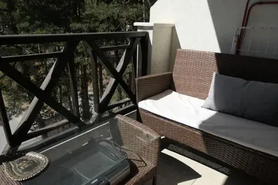 a view of a balcony with a table and a couch at Апартамент Мия Deluxe in Velingrad