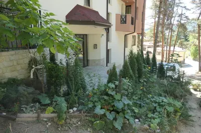 a garden in front of a house at Апартамент Мия Deluxe in Velingrad