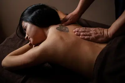 a woman getting a back massage with a heart tattoo at Katalina Resort in Tsigov Chark