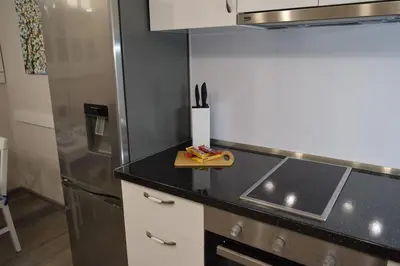a kitchen with a sink and a refrigerator at SWEET HOME PLOVDIV in Plovdiv