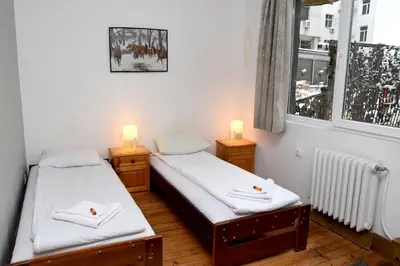 two twin beds in a room with a window at Santa Sofia in Sofia