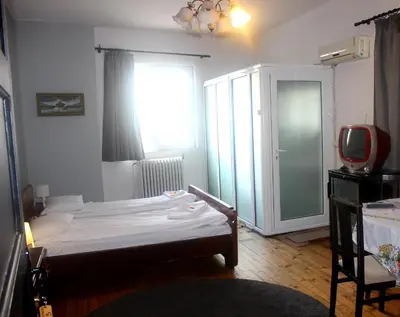 a small bedroom with a bed and a window at Santa Sofia in Sofia