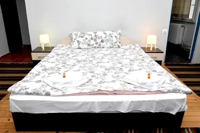 a bed with white towels on it in a room at Santa Sofia in Sofia